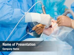 Surgery dentists during implant placement PowerPoint Template