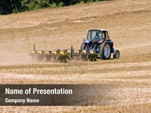 Tractor unidentifiable farmer seeding field