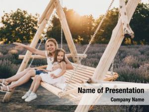Mother Swings Her Daughter On A Swing PowerPoint Template