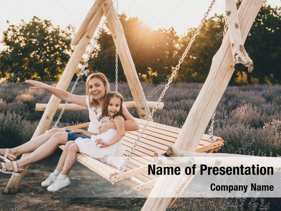 Mother Swings Her Daughter On A Swing