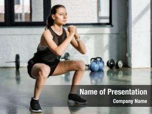 Doing focused sportswoman squats fitness