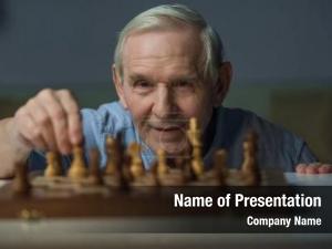 Man senior smiling playing chess