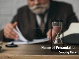 Working senior writer hourglass standing PowerPoint Template