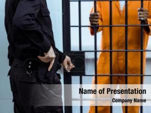 Guard cropped prison putting hand PowerPoint Template