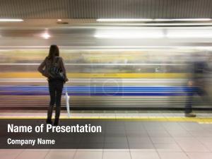 Lone woman watching subway speed by