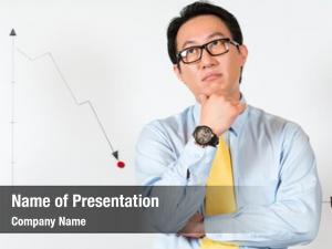 Asian Chinese Business Manager or employee presenting negative economic forecast or statistic or graph on a office whiteboard 