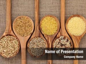 Cereal and grain selection of bulgur wheat, buckwheat, couscous, rye grain and brown and wild rice in olive wood spoons on hessian sacking 