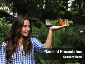 Biodiversity: butterfly sitting on the hand of a young woman in the forest