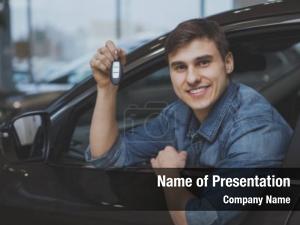 Male holding car keys with car on  