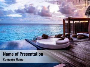 Luxury beach resort, bungalow near endless pool over sea sunset, PowerPoint Template