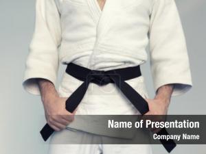 Karate fighter tightening belt black