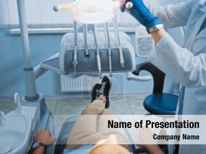 Dentist cropped view adjusting lamp PowerPoint Template