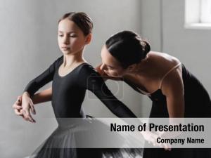 Teacher young ballet assisting girl