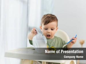 Spoon child holding pouring vegetables PowerPoint Template