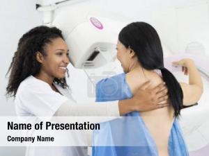 Patient nurse assisting undergoing mammogram