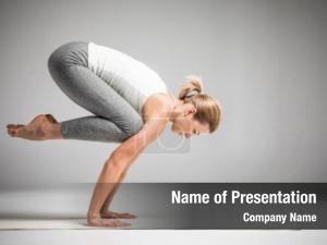 Yoga woman practicing standing bakasana