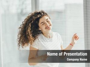 Happy Woman Listening Music in Headphones and Dancing PowerPoint Template
