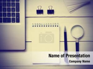 Notebook with Magnifying Glass on Wooden Workplace PowerPoint Template