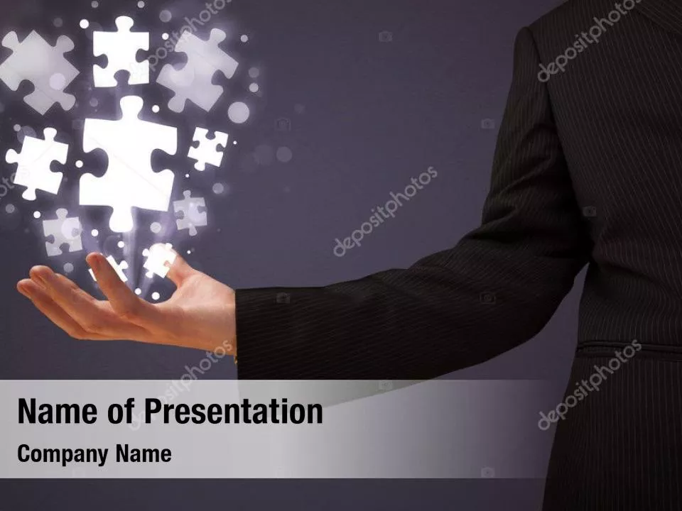 Businessman Hand with Glowing Puzzle Pieces